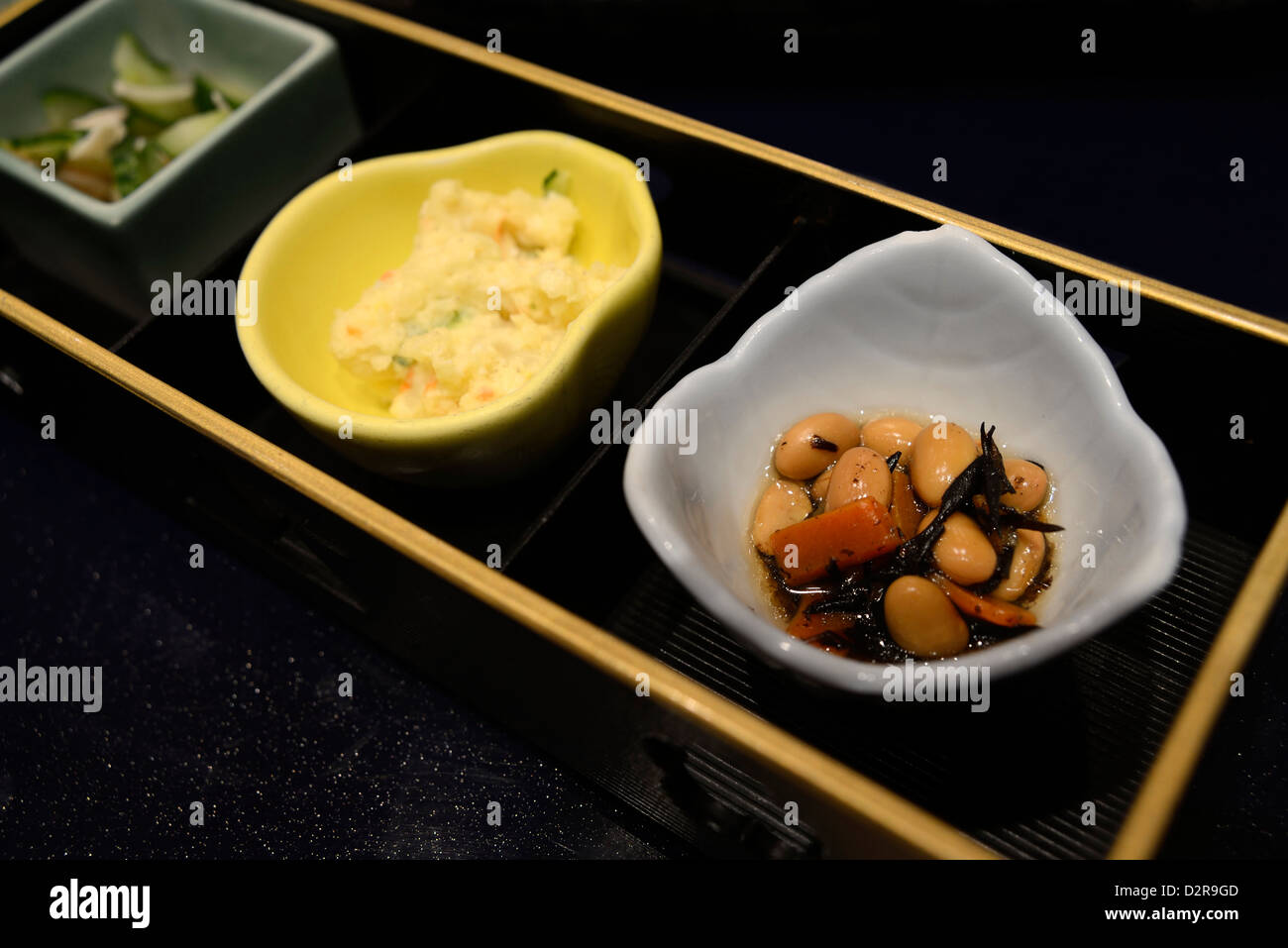 Japanese appetizer on long rectangular tray with dark background table, restaurant, Shanghai City, China. Stock Photo