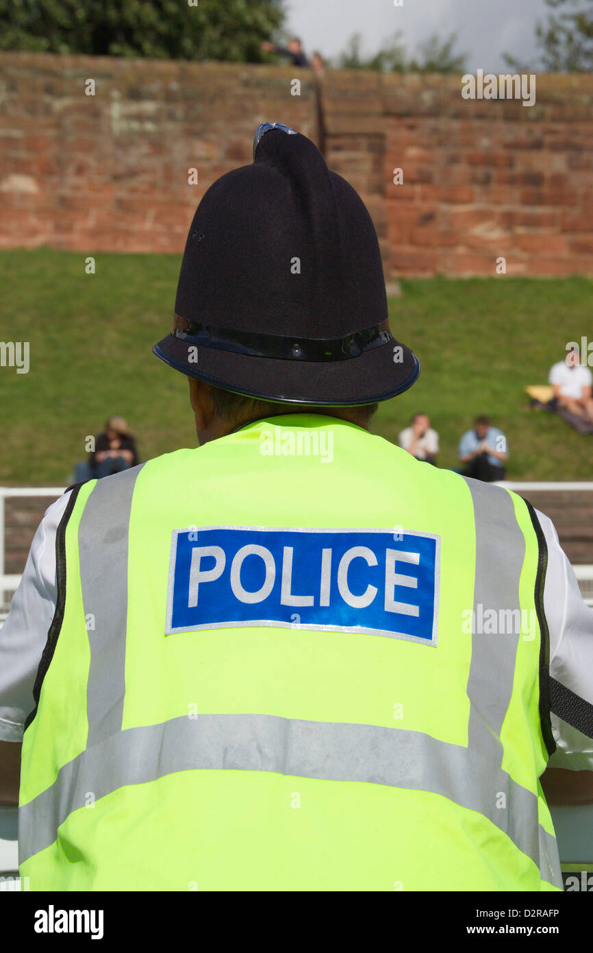 Policeman wearing a yellow high visibility jacket Stock Photo