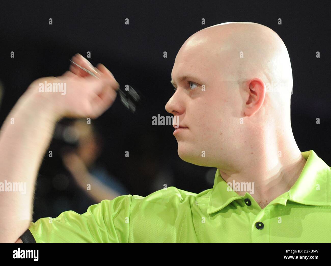 Dutch dart player Michael van Gerwen throws a dart during a show tournament  with HSV players