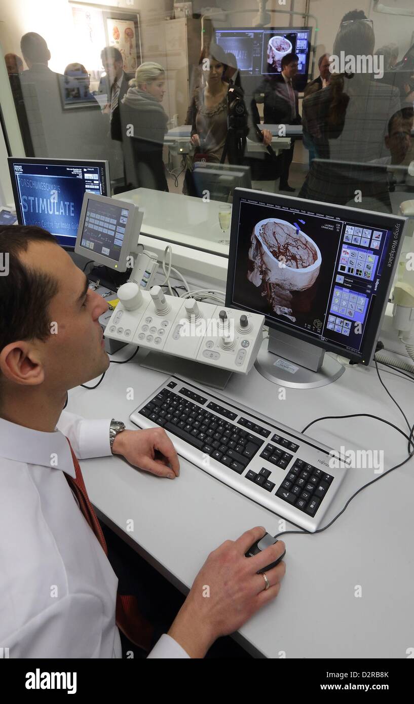 Lab engineer Axel Boese monitors computer screens in the laboratory of the new medical research campus 'Stimulate' of the Otto-von-Guericke University in Magdeburg, Germany, 30 January 2013. The aim of the research campus is to develop efficient and gentle therapeutic methods for various illnesses and diseases, which will also reduce health care costs. Photo: Jens Wolf Stock Photo
