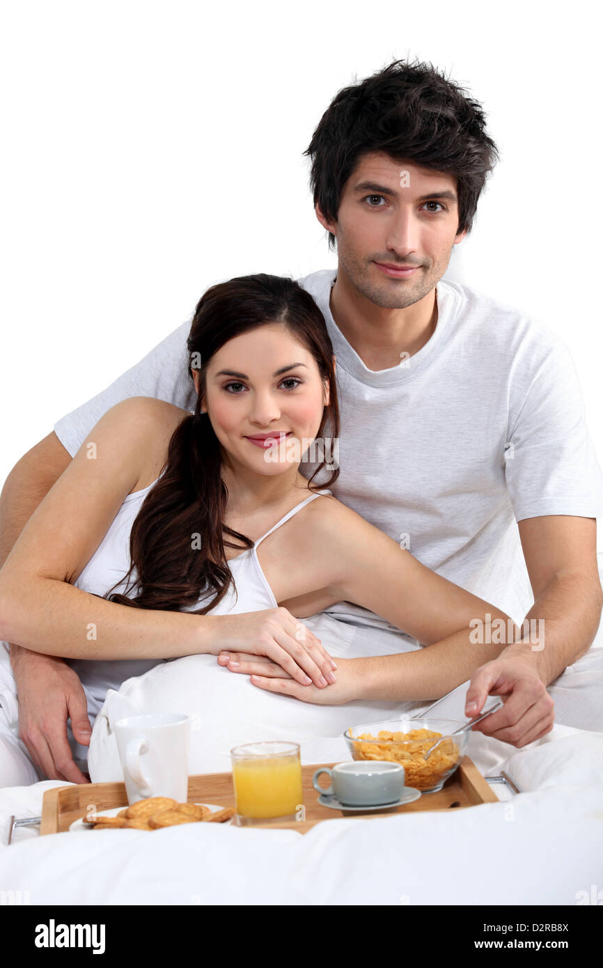 Amorous couple lying in bed hires stock photography and images Alamy