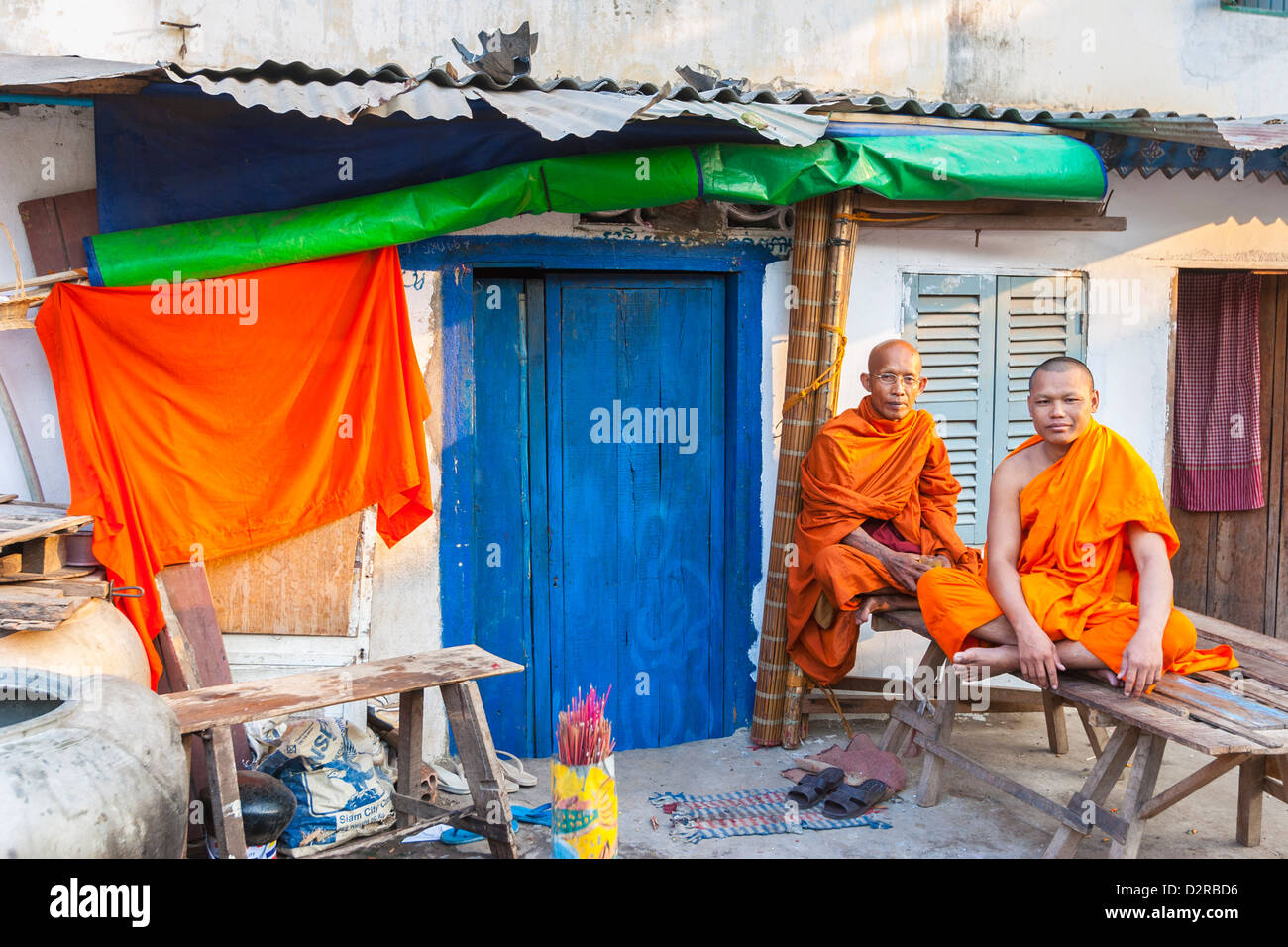 Buddhist monks by blue door, Phnom Penh, Cambodia, Indochina, Southeast Asia, Asia Stock Photo