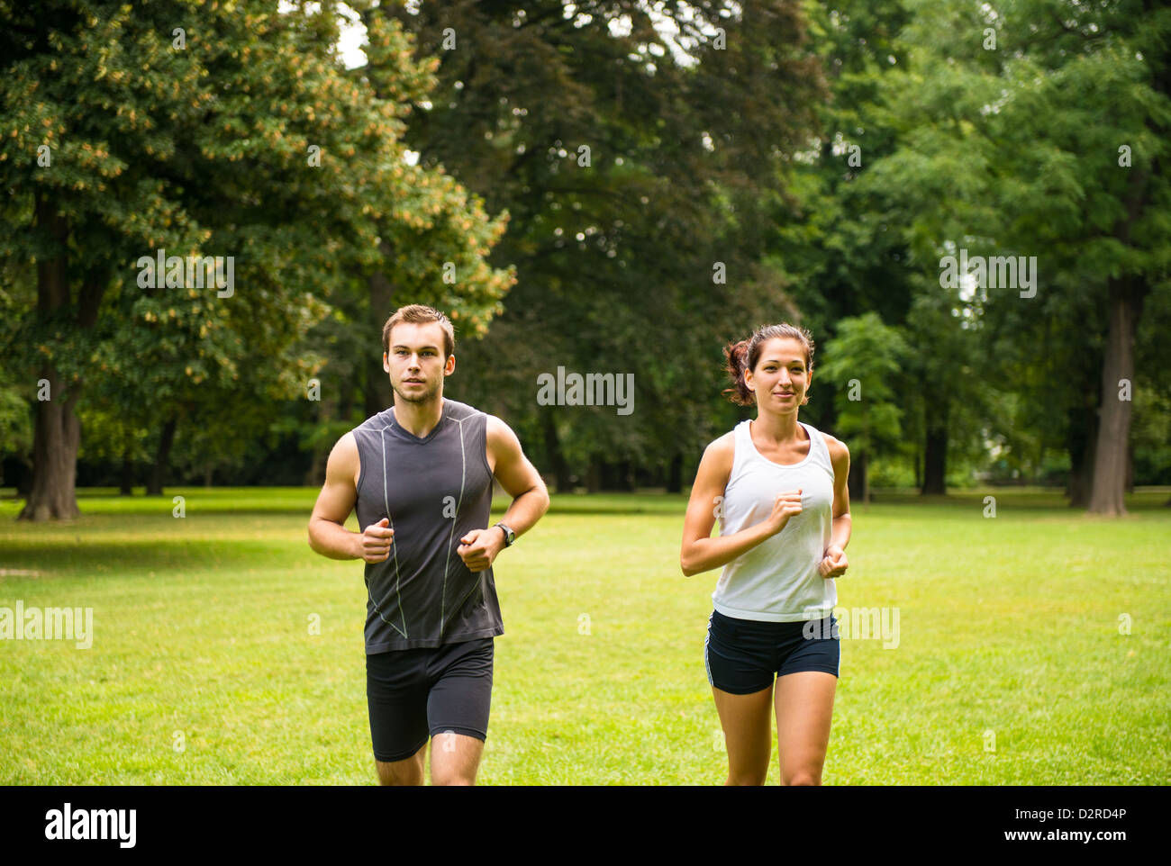 Fitness couple - young man and woman jogging outdoor in nature Stock Photo