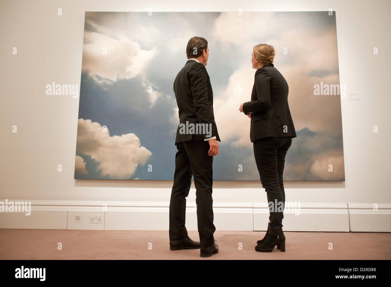 London, UK. 31 January 2013.  Visitors stand in front of an oil on canvas of 1976 entitled 'Wolke (Cloud)' by Gerhard Richter (Est. £7-9 million) during the press preview of the forthcoming Sotheby's February sales of Impressionist & Modern Art and Contemporary Art in London, including works by Picasso, Bacon, Monet, Richter, Miró, Basquiat. Credit:  pcruciatti / Alamy Live News Stock Photo