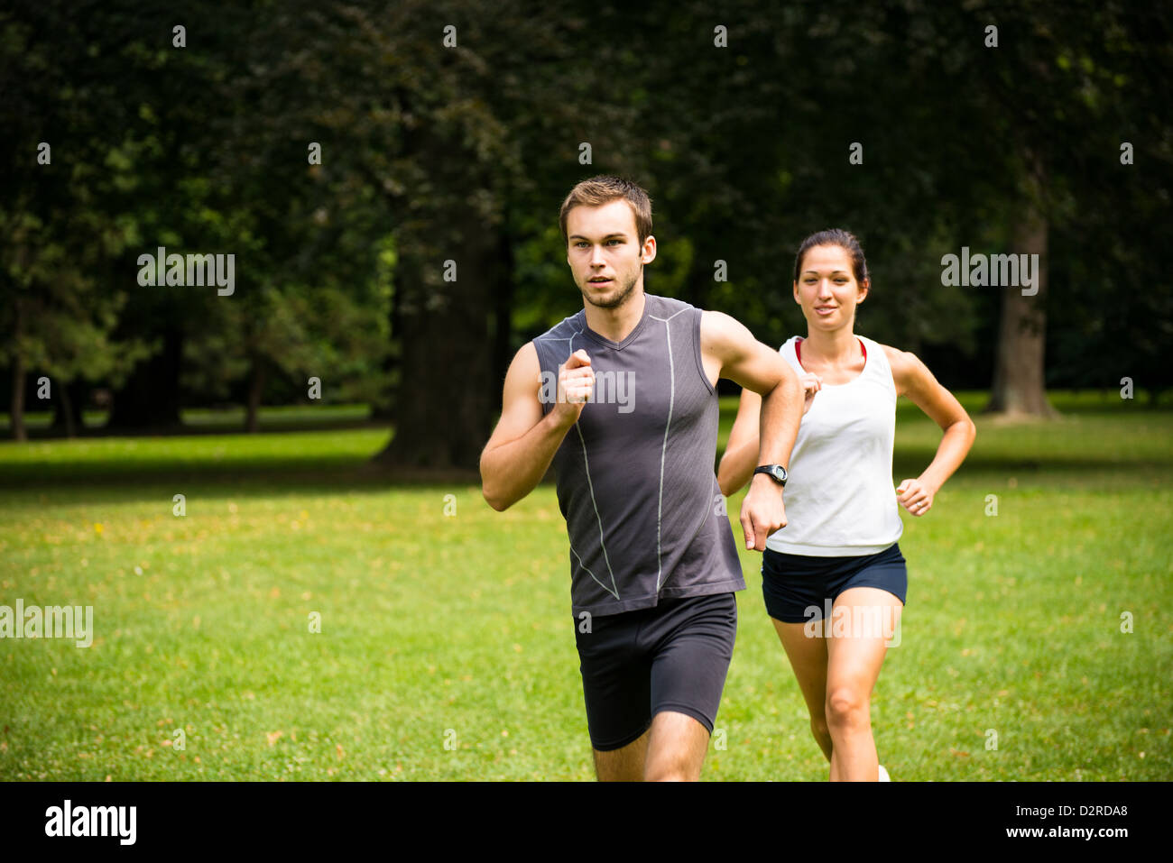 Young fitness couple jogging outdoor, man first Stock Photo