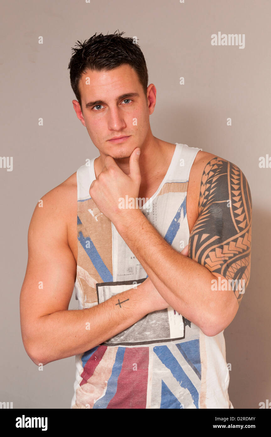 Attractive handsome hunky young man in singlet vest. Stock Photo