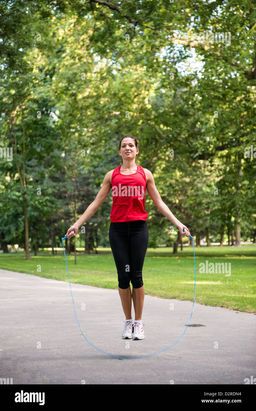 Young fitness woman exercising - jumping with skipping rope Stock Photo