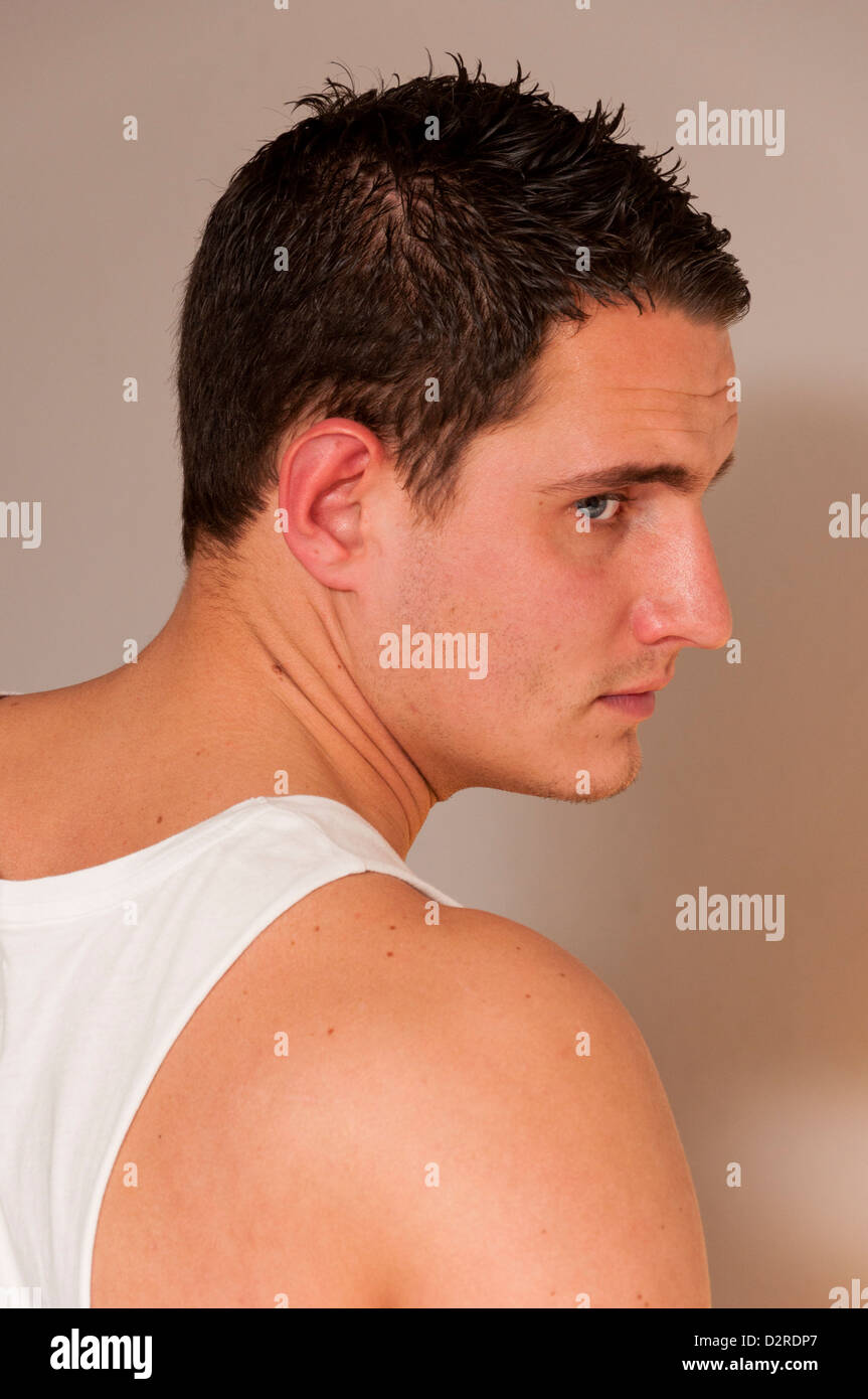 Attractive handsome hunky young man in singlet vest. Stock Photo