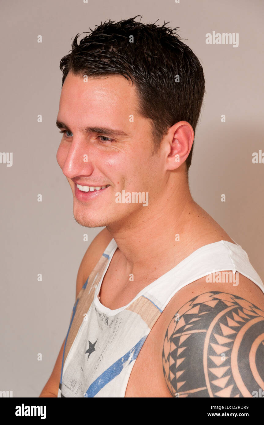 Attractive handsome hunky young man in singlet vest. Stock Photo