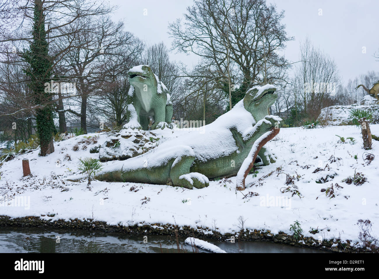 Snow covered Dinosaurs at Crystal Palace Park, London, UK Stock Photo