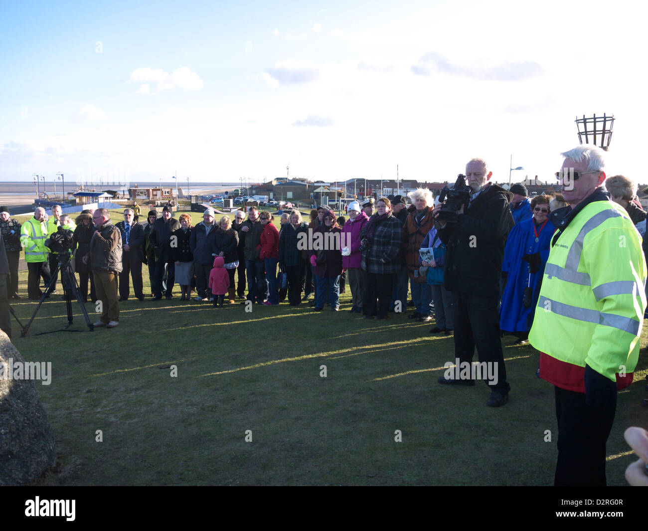 Part of the crowd awaiting the unveiling of the memorial plaque to