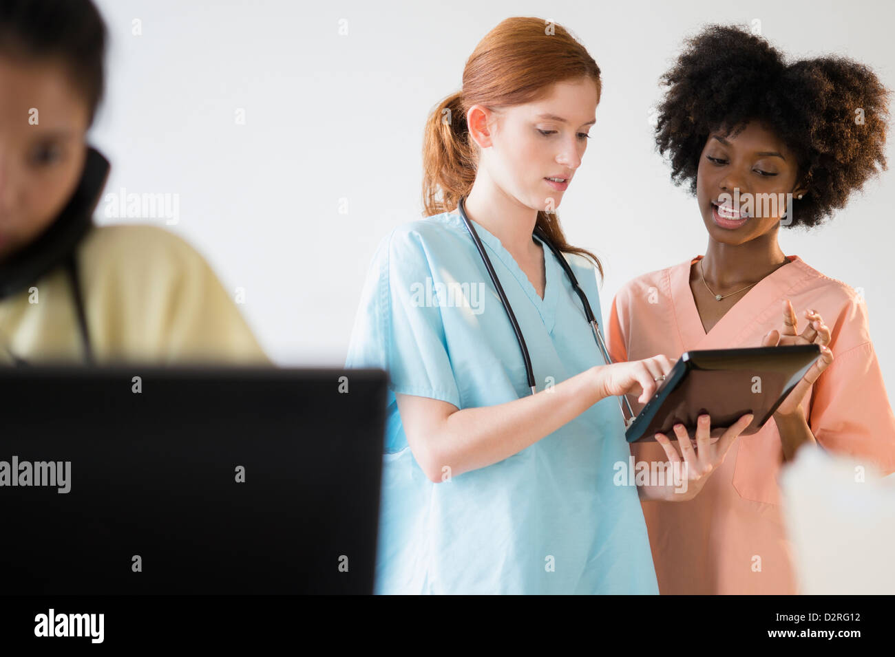 Nurses using tablet computer in hospital Stock Photo
