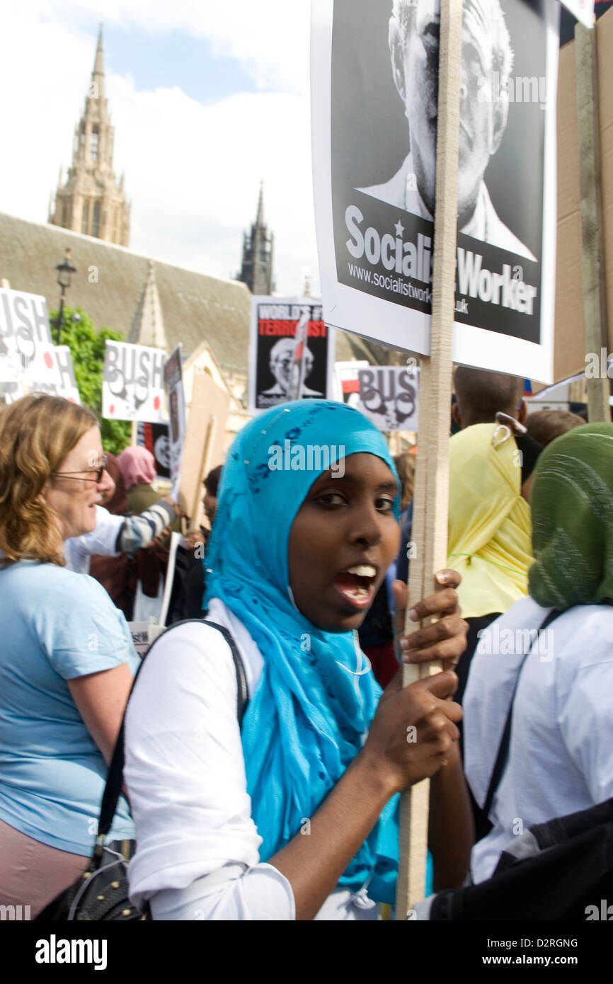 A black Muslim female protester holds up a protest sign at a demonstration in Central London in the UK. Stock Photo