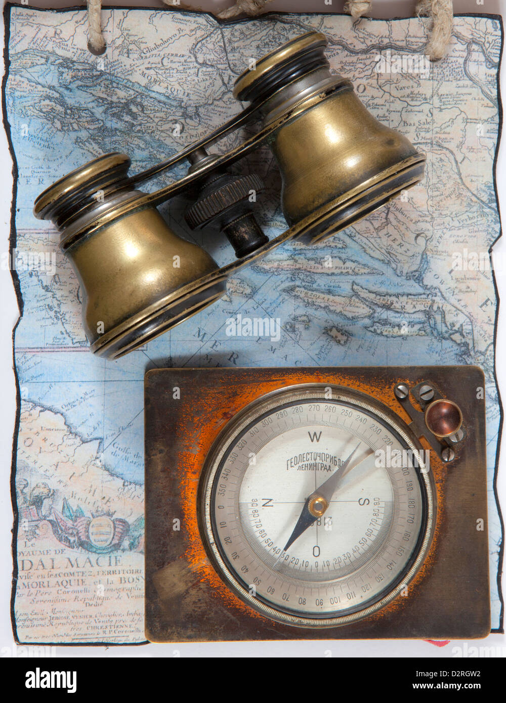 An old binocular and compass on an old map Stock Photo - Alamy