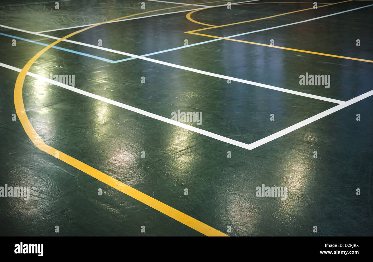 Green shining floor of sports hall with marking lines Stock Photo