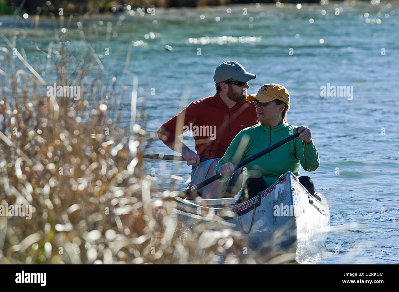 Man and woman paddling a canoe on Lady Bird Lake, Austin Texas Stock