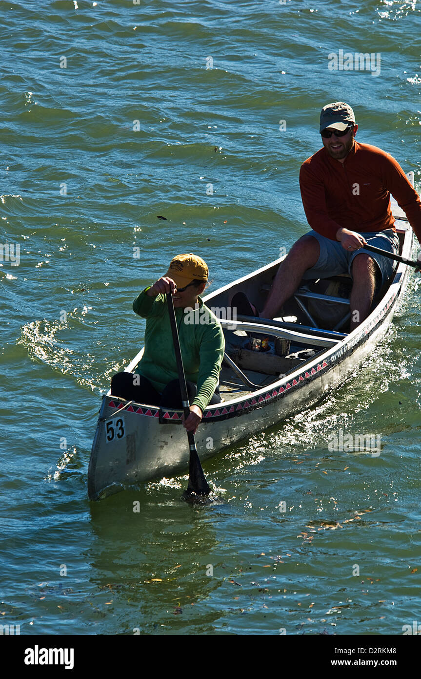 Man and woman paddling a canoe on Lady Bird Lake, Austin Texas Stock