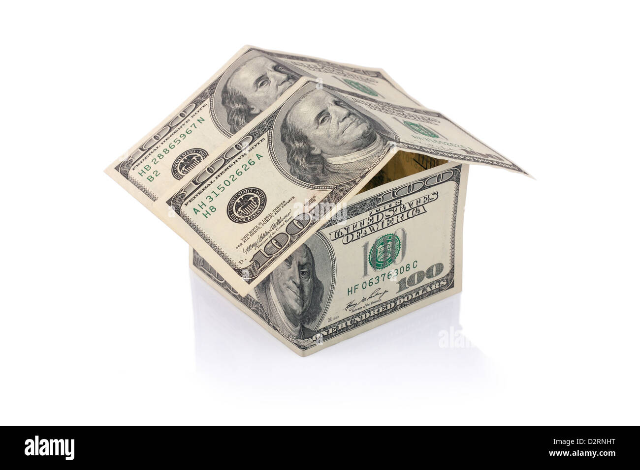 House built with Dollar money bills isolated on white background with