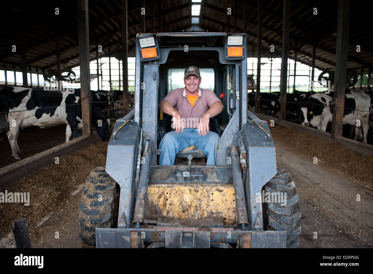 Man operating machinery on a farm Stock Photo
