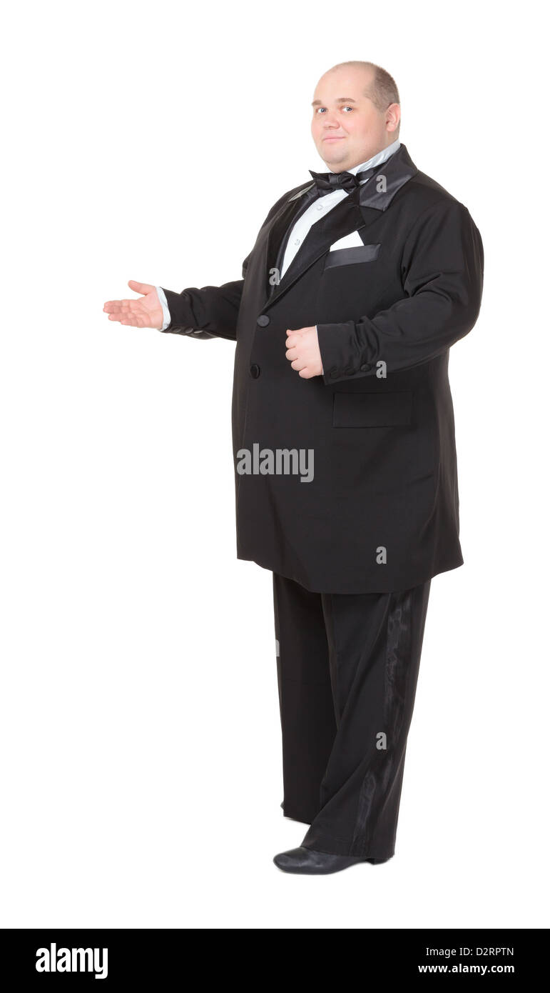 Elegant fat man in a dinner jacket and bow tie smiling charmingly as he holds out his hand to
