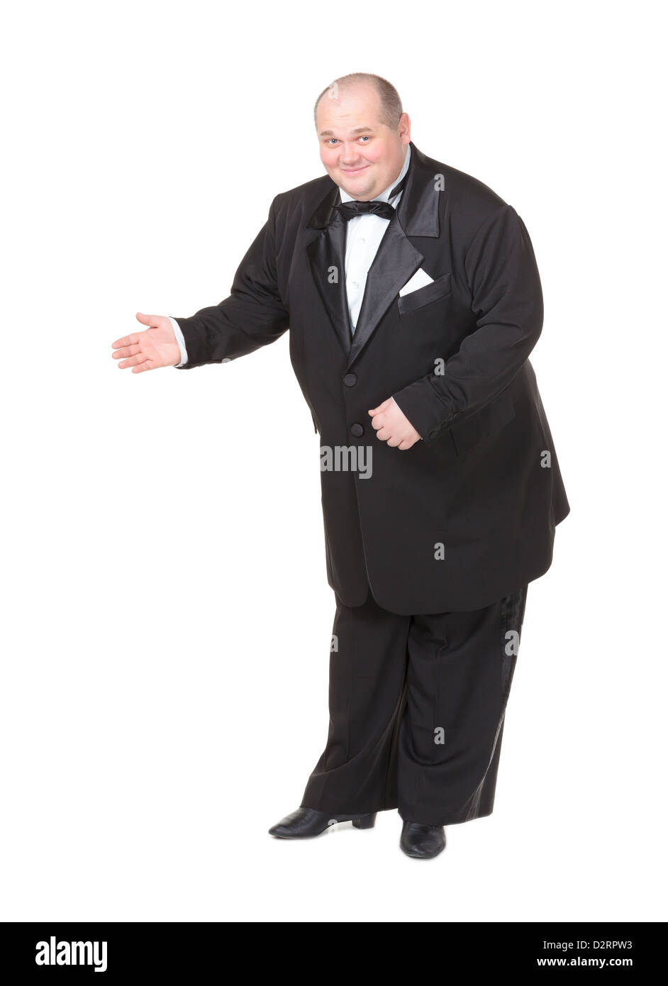 Elegant fat man in a dinner jacket and bow tie smiling charmingly as he holds out his hand to