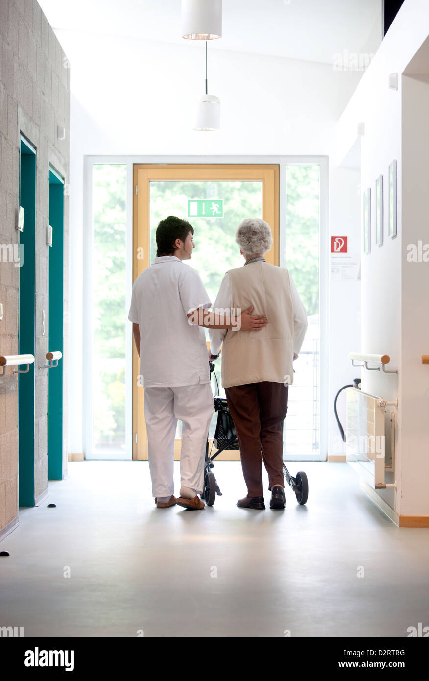 Essen, Germany, a Zivilidienstleistender accompanies a patient during gait training Stock Photo