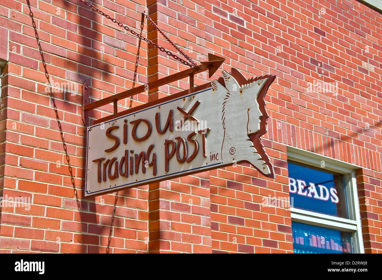 Sioux Trading Post sign on outside of brick souvenir building in Rapid City Stock Photo