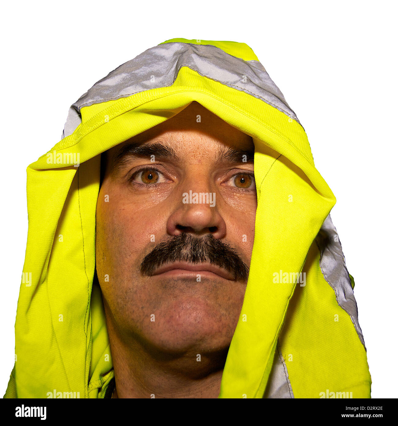 A man has a reflective vest pulled over the head to put it in place properly Stock Photo