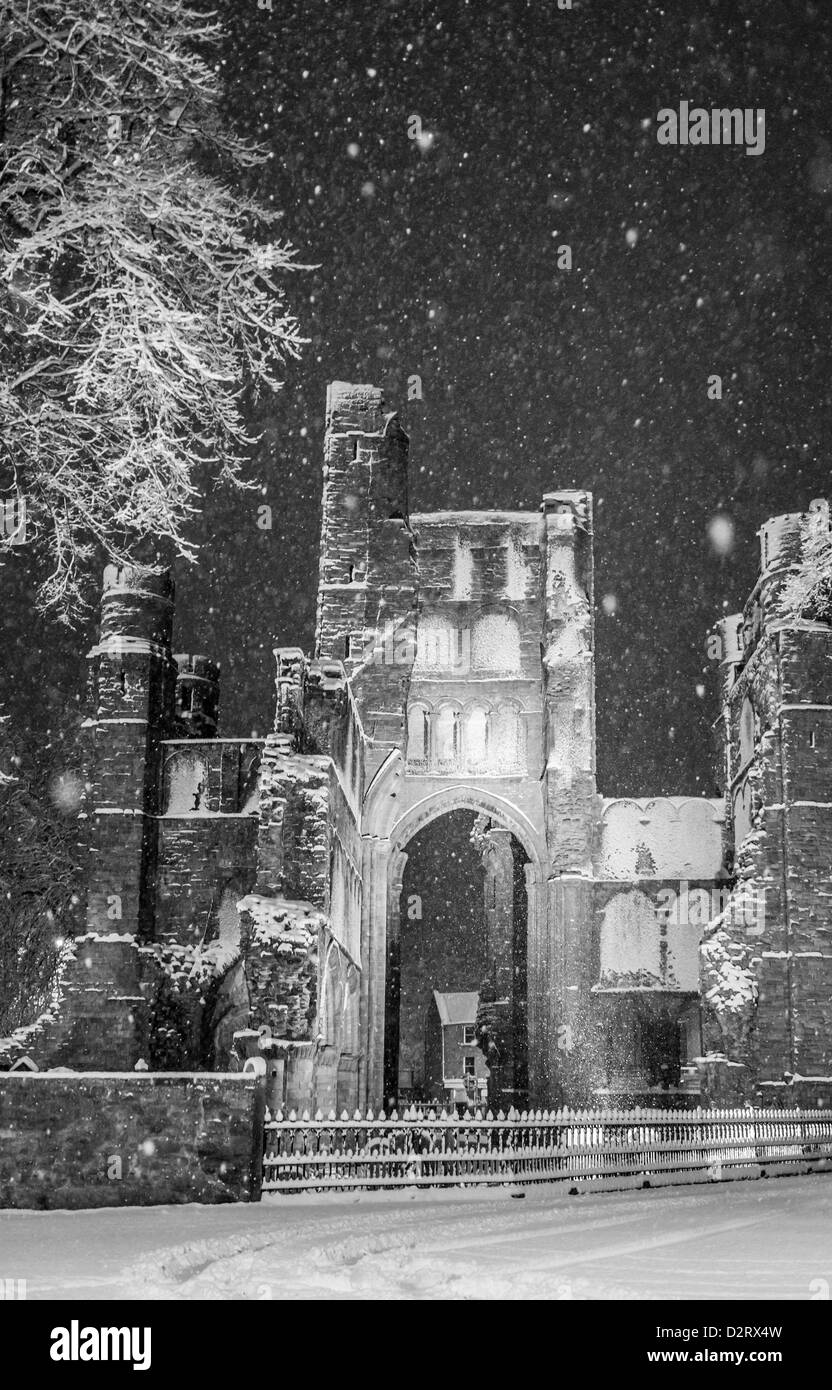 Kelso Abbey in Scotland, in falling snow, at night - monochrome Stock Photo