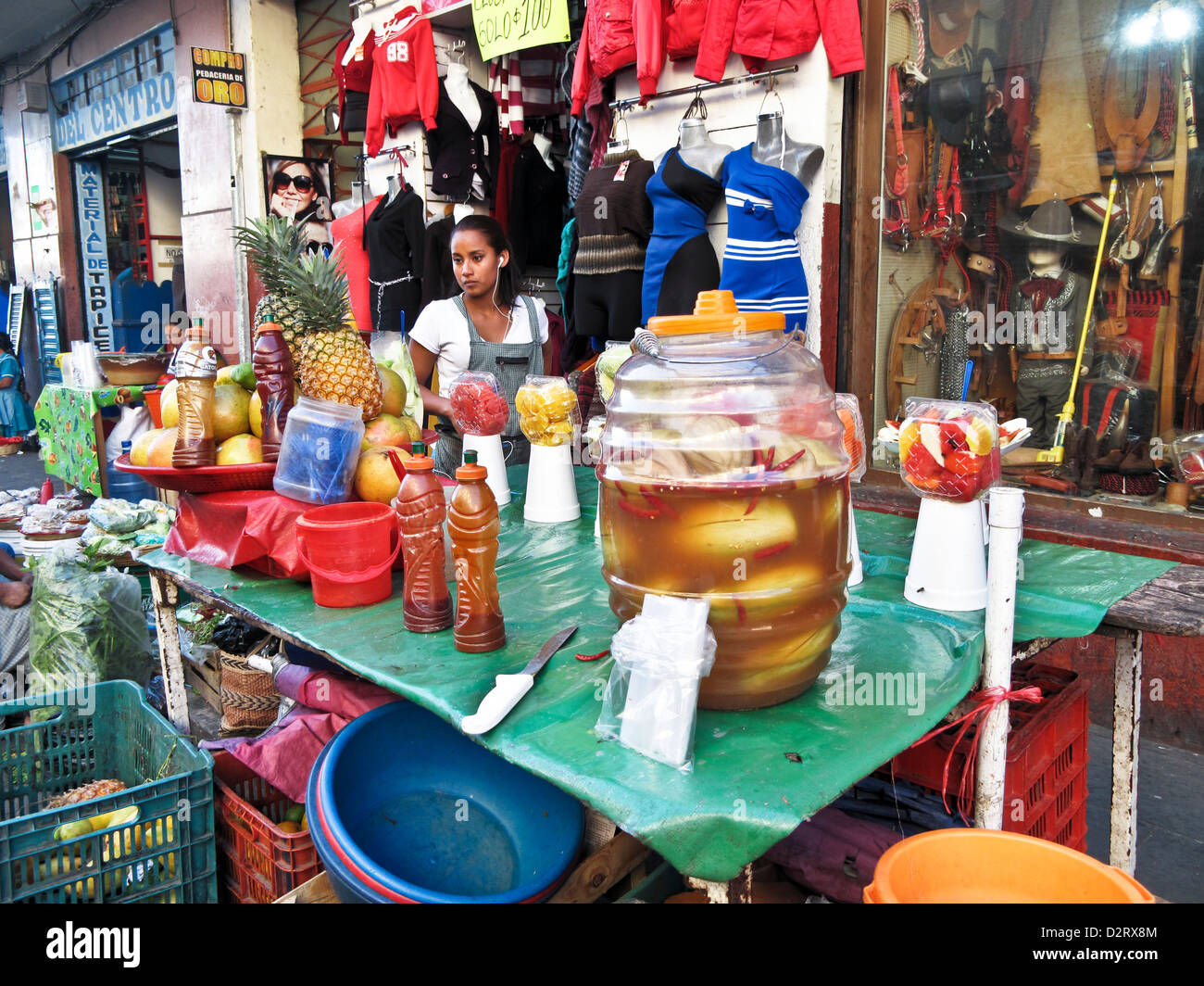 pretty young Mexican girl street vendor selling cut up fruit & agua de