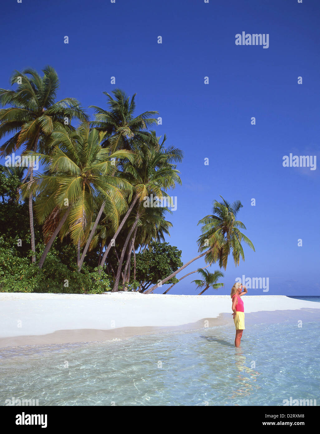Young woman on tropical beach, Kuda Bandos Island, Kaafu Atoll, Republic of Maldives Stock Photo