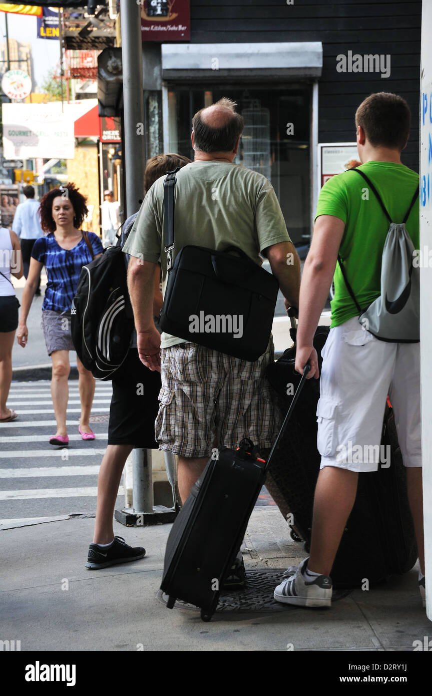 Tourists with luggage on New York street, USA Stock Photo Alamy