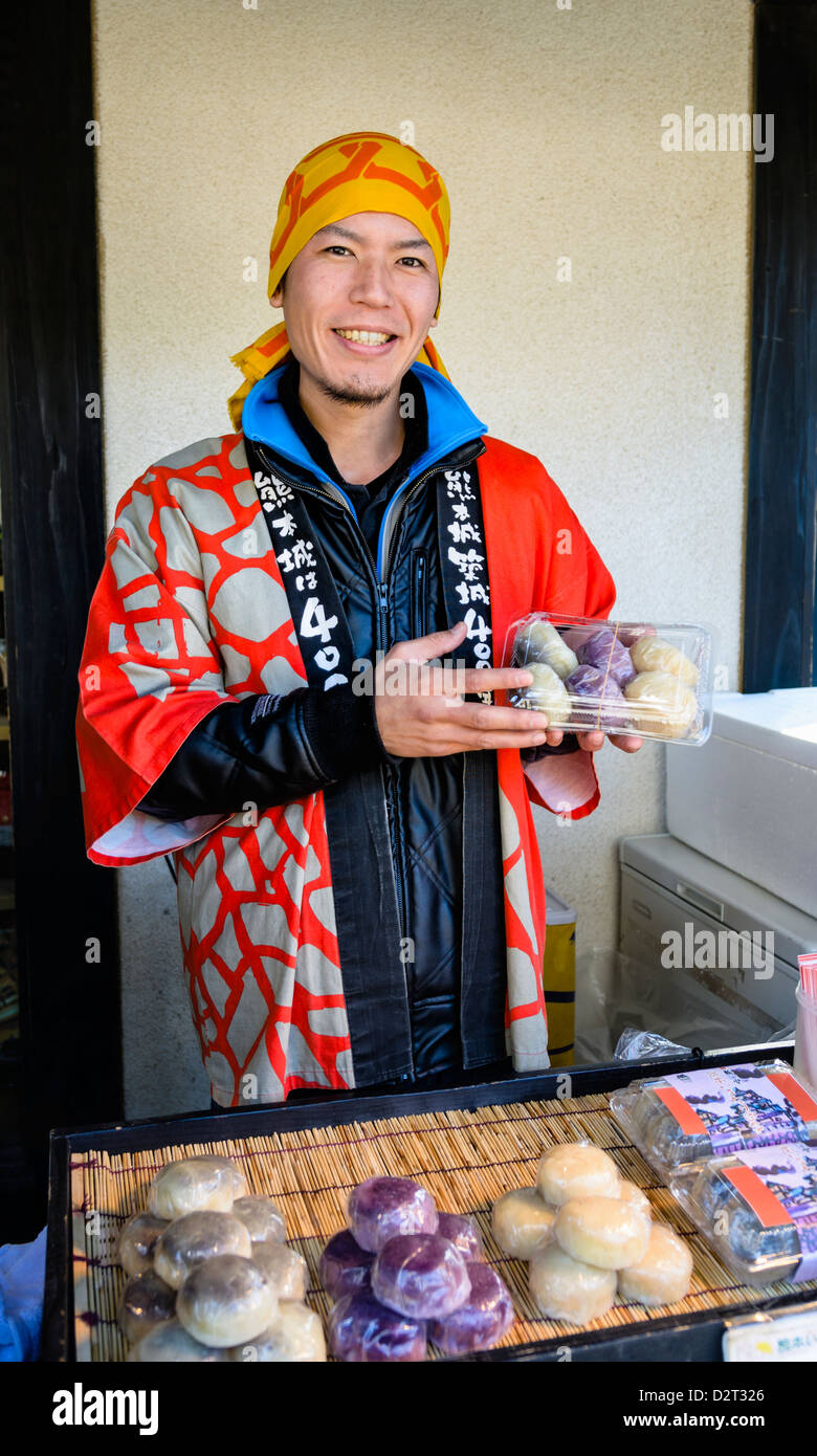 Young man selling traditional desserts, wearing traditional costume. Such food is popular Stock Photo