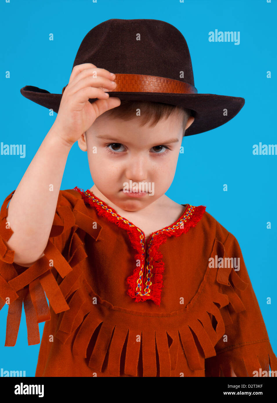 little boy wearing a cowboy hat a over blue background Stock Photo - Alamy