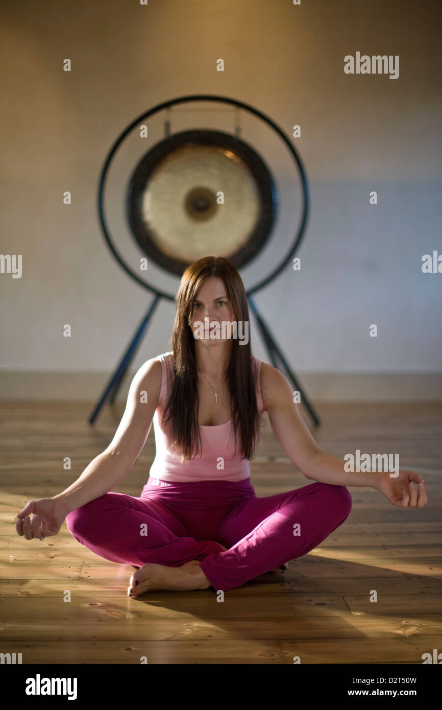 Woman demonstrating lotus position in Yoga Stock Photo