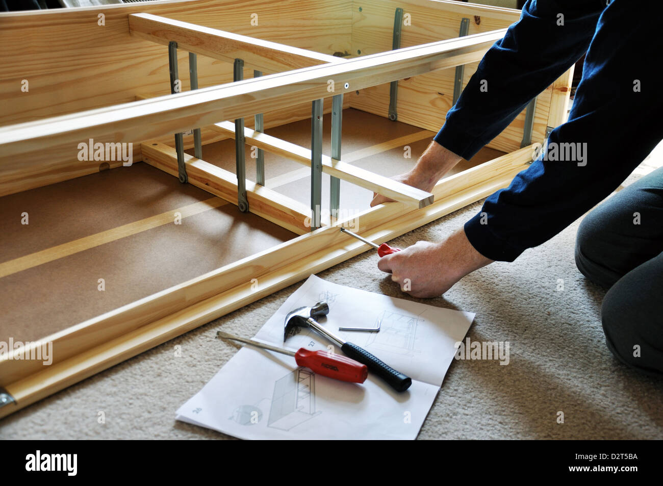 Man Assembling Piece Of Furniture From Ikea Store Stock Photo