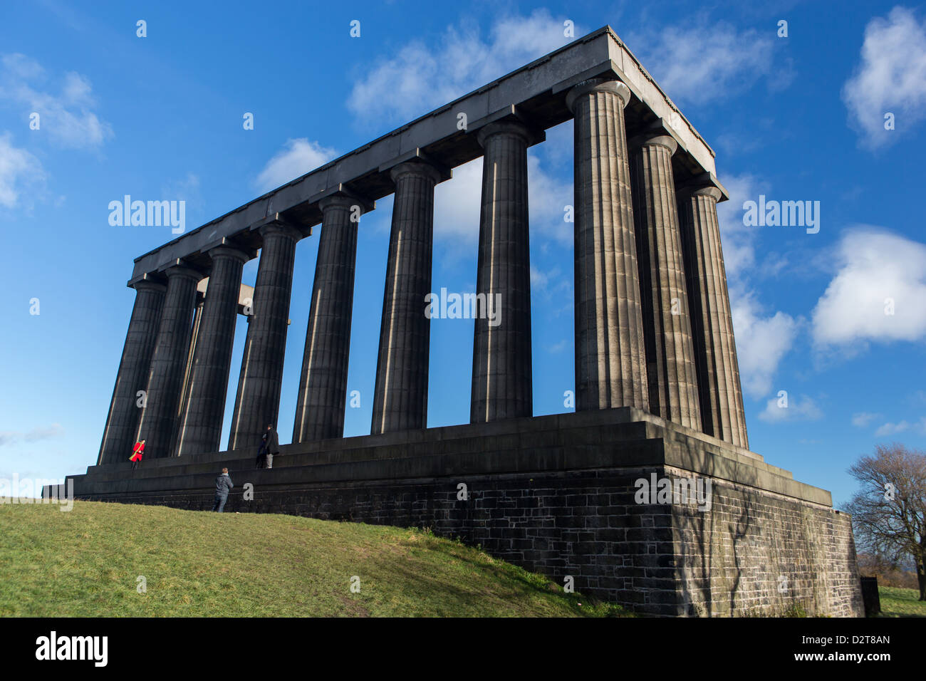 Tourists pose for pictures on the un-finished National Monument of Scotland on Calton Hill in Edinburgh Stock Photo