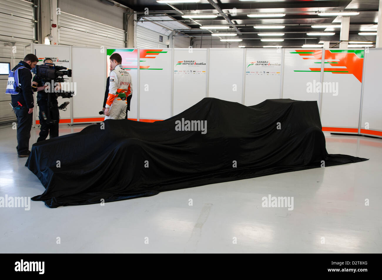 Silverstone, UK. 1st February 2013.  Force India's 2013 F1 car, the VJM06, is under wraps ahead of its reveal.  Driver Paul di Resta (GBR) is stood behind the car, being interviewed for Sky News.  Credit:  Elaine Scott / Alamy Live News Stock Photo