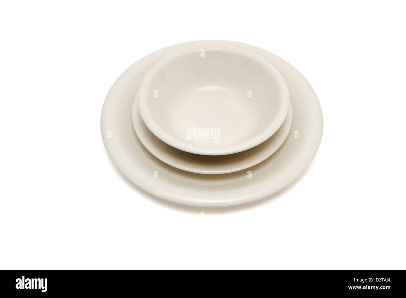 Plain beige dinner plate, soup plate and saucer isolated Stock Photo