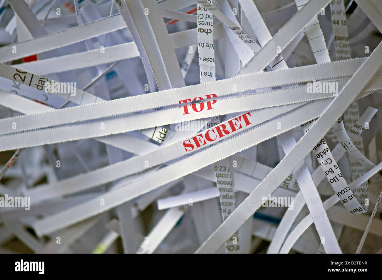 Close-up of shredded paper with the focus on the words 'TOP SECRET' printed red Stock Photo