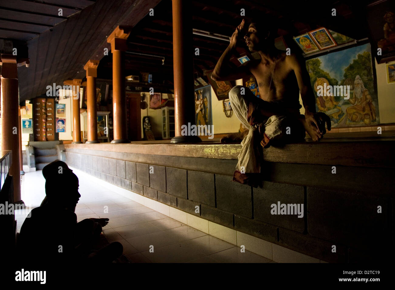 A teacher encourages students at the Vadakke Madham Brahmaswam in Thrissur, Kerala, India. Stock Photo