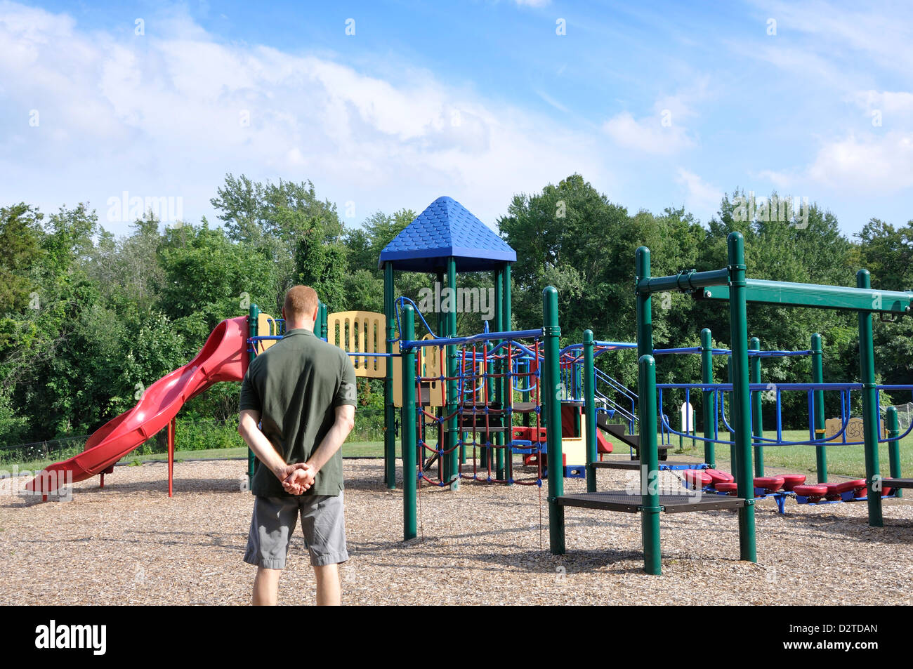 Adult man gazing over playground Stock Photo
