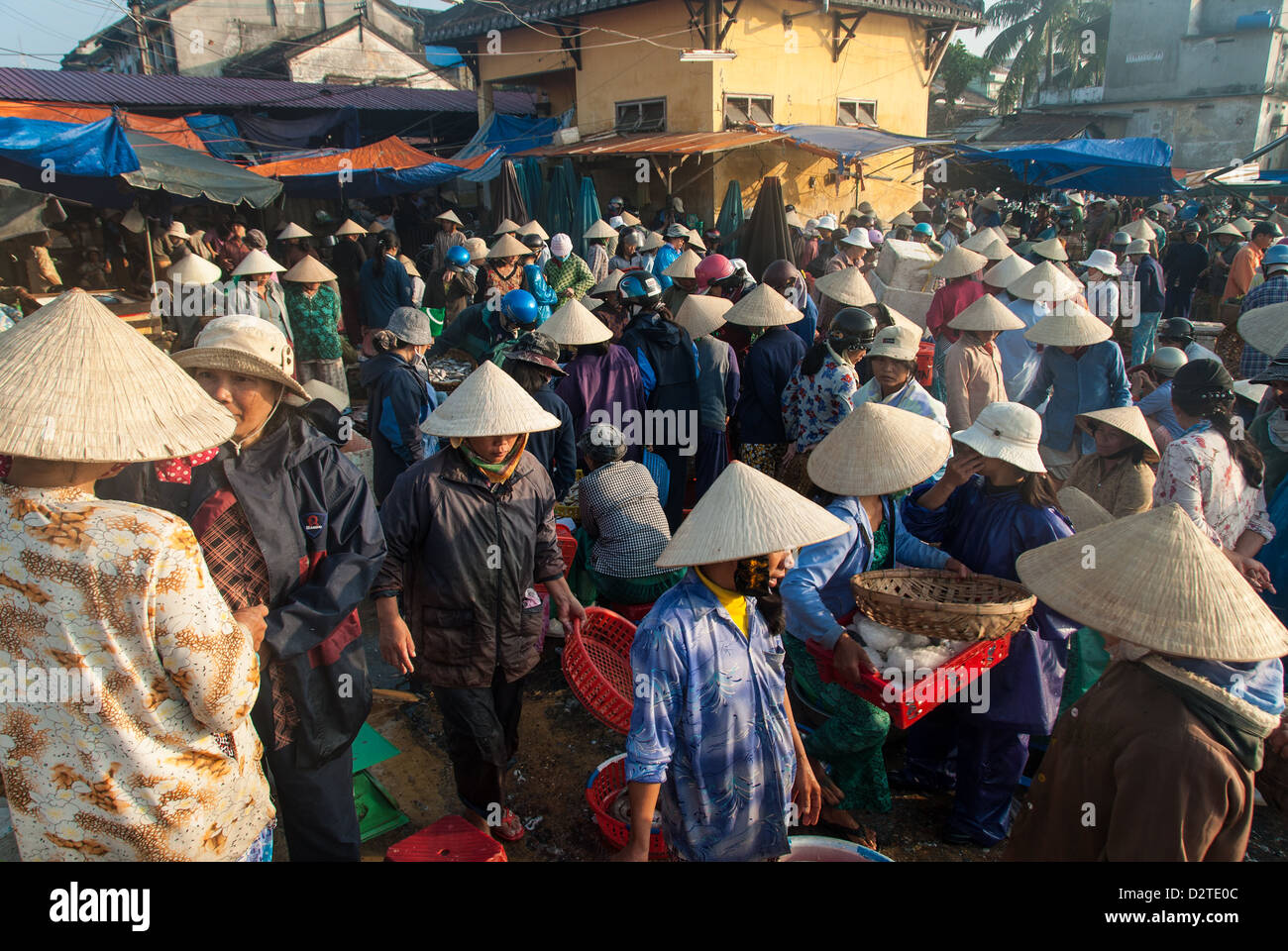 Unidentified men and women buy and sell sea food on January 10, 2008 in Hoi An, Vietnam. Stock Photo