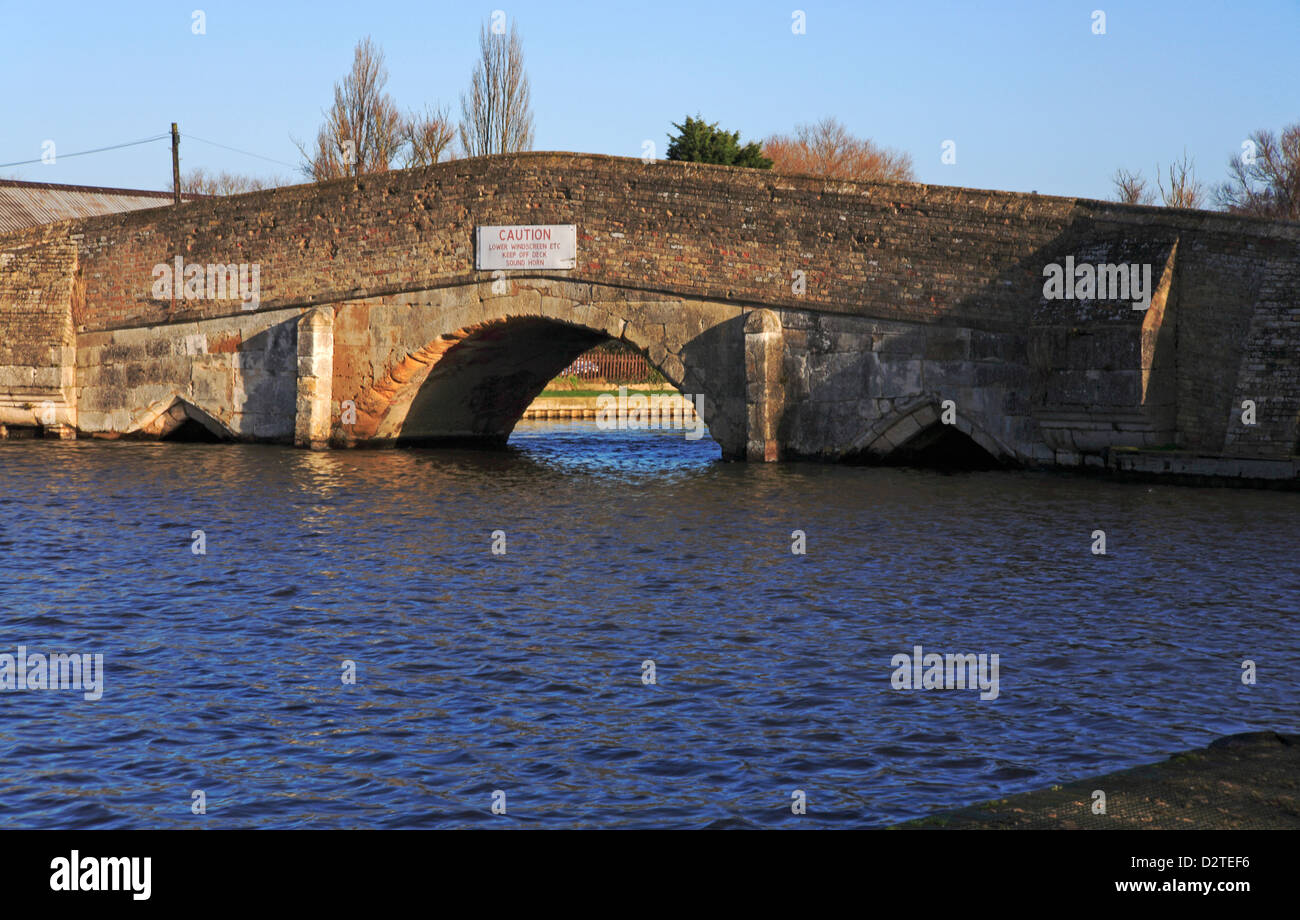 A view of the River Thurne and medieval bridge on the Norfolk Broads at