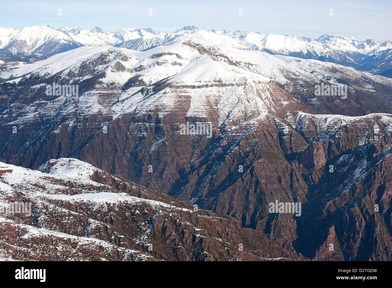 AERIAL VIEW. The Cians Gorge with its distinctive red-brown pelite rock and the Mercantour Alps on the horizon. French Riviera's backcountry, France. Stock Photo