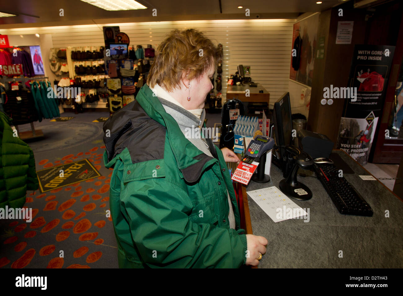 Important Notice Please Remove Your Card sign on credit card machine in shop & woman paying using her M&S  Mastercard Stock Photo