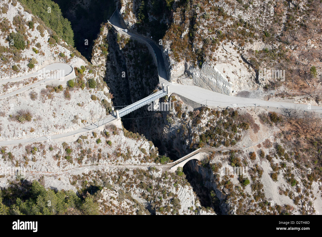 AERIAL VIEW. Historic and modern bridges over a deep canyon (height: approximately 90m). La Croix-sur-Roudoule, French Riviera's backcountry, France. Stock Photo
