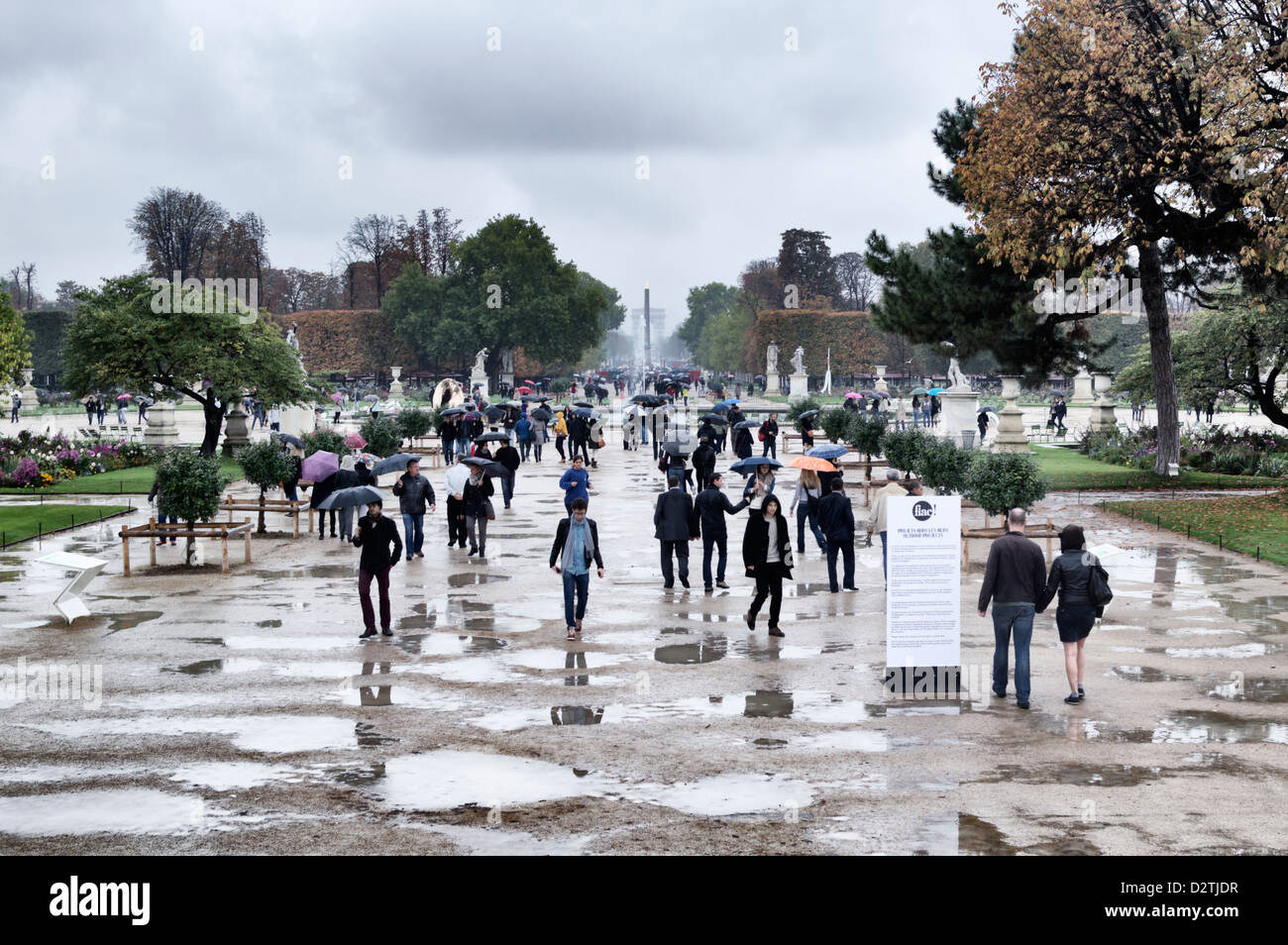 Paris, France - people with umbrellas walking through the Jardin des Tuileries on a rainy day Stock Photo