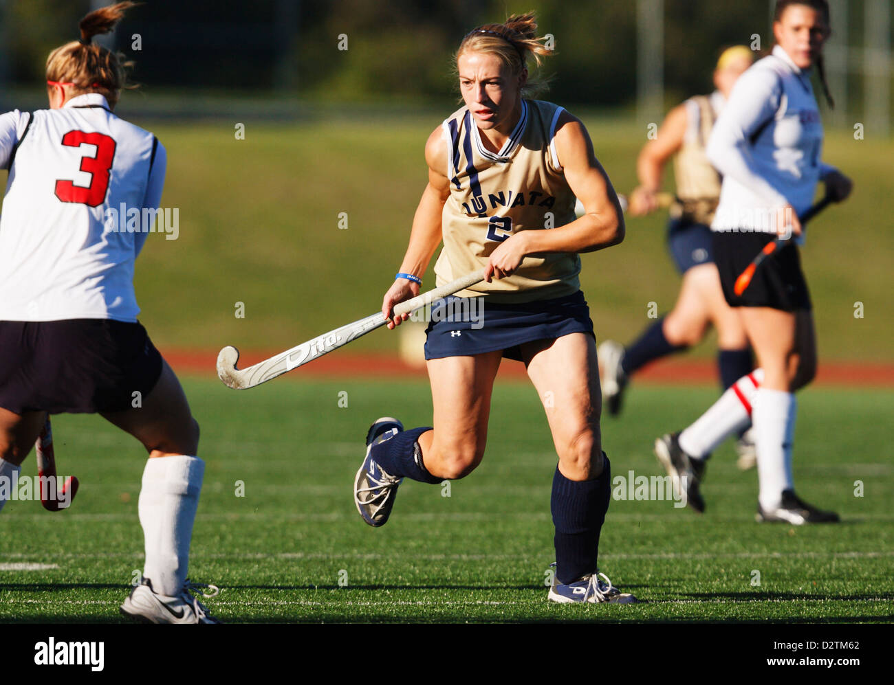A Juniata College player (2) in action during the Landmark Conference field hockey championship against Catholic University. Stock Photo
