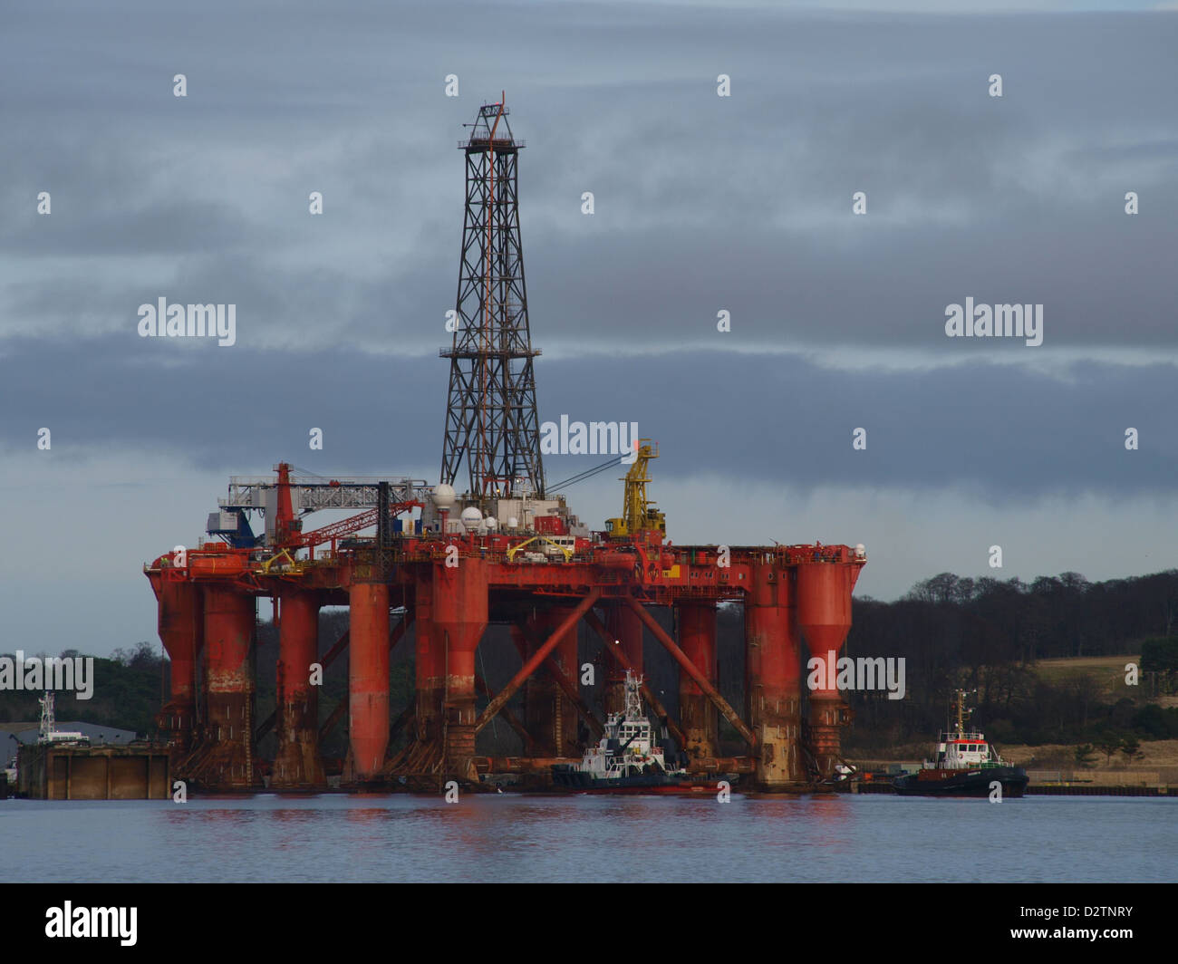 The Borgston Dolphin oil rig being maneuvered from the dry dock at the Nigg energy Park, on the Cromarty Firth in East Ross. Stock Photo